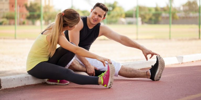 Attractive,Young,Latin,Couple,Stretching,Their,Legs,Together,Before,Going