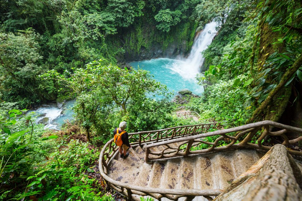 Majestic waterfall in the rainforest jungle of Costa Rica. Tropical hike.